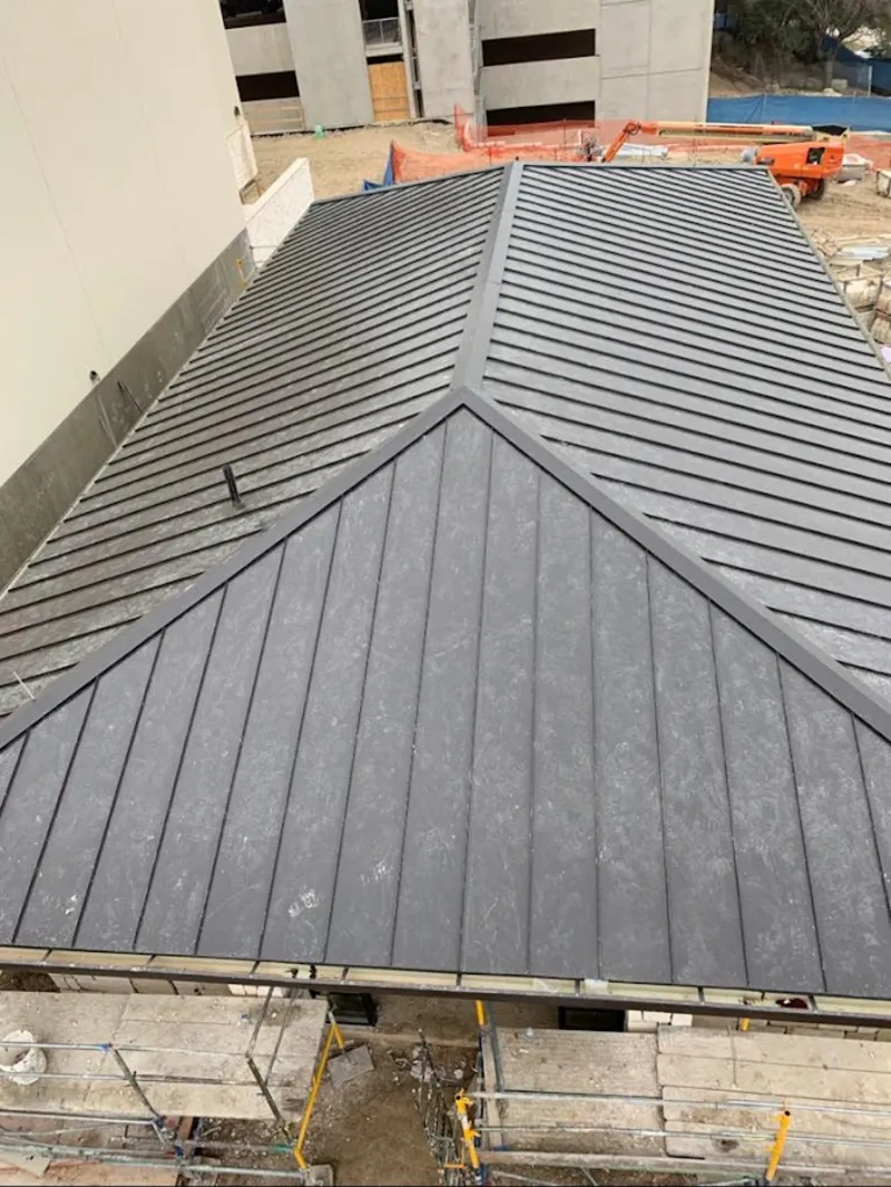 Commercial metal roof construction with crane equipment in Lake Forest