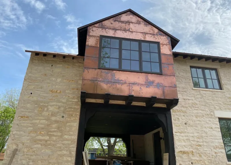 Copper metal panel facade on a stone building for Skylight Installation in Lake Forest